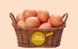A basket of brown eggs on a tan background.