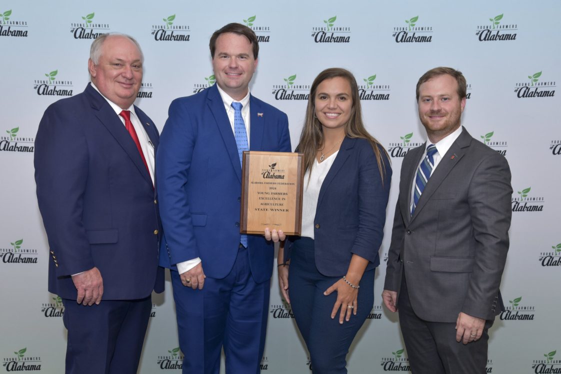 Will and Ali Gotcher (center) pictured with Farmers Federation President Jimmy Parnell (left) and Hunter McBrayer, Young Farmers division director (right).