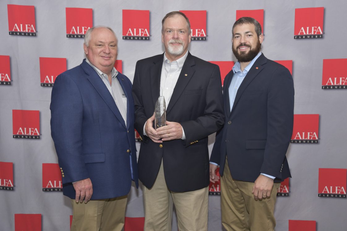 Dennis Brothers, center, received the Alabama Farmers Federation’s Duncan Award for Excellence in Production Agriculture and Forestry Extension Aug. 3.