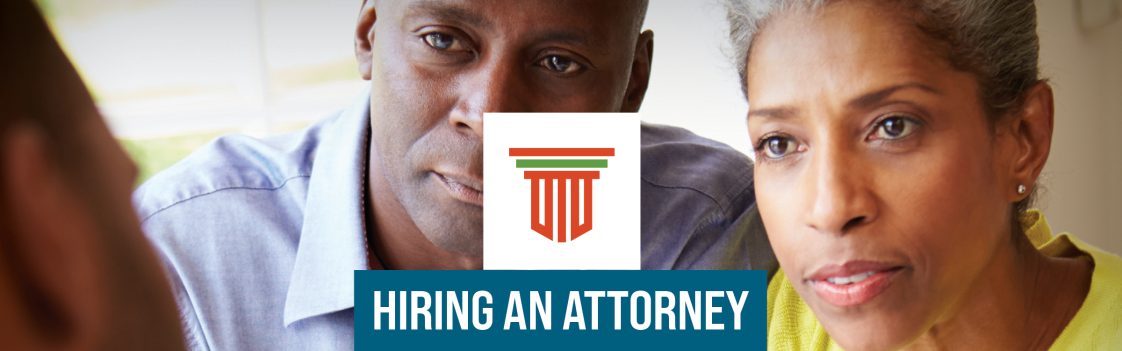 A picture of a man and woman talking to a person off camera with the words Hiring an Attorney.