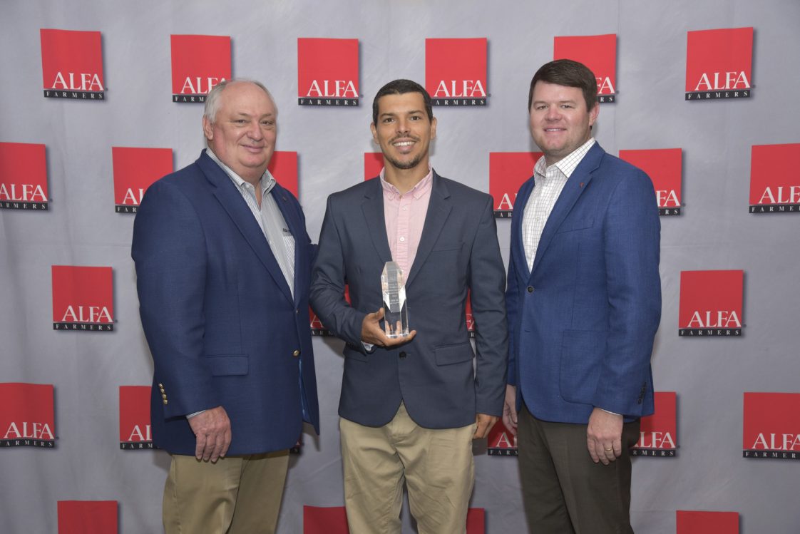 Andre da Silva, center, received the Alabama Farmers Federation’s Rittenour Award for Excellence in Production Agriculture & Forestry Research Aug. 3. Da Silva was honored during the Federation’s Farm & Land Conference in Montgomery. Da Silva is an associate professor and Alabama Cooperative Extension System (ACES) vegetable specialist and has been instrumental in developing best management practices for high-yielding, high-quality crops through variety trails.