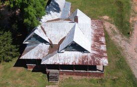 An older house with a rusted tin roof.
