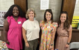 Four members of the Washington County Extension EFNEP team posing for a picture at an event.