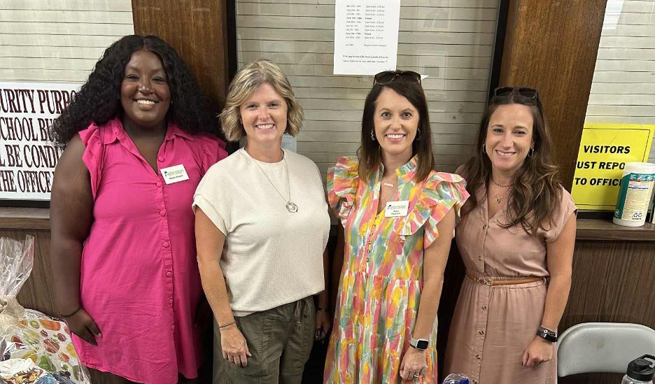 Four members of the Washington County Extension EFNEP team posing for a picture at an event.