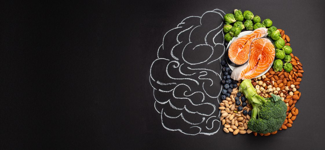 A chalk board with a brain on one side and fruits/vegetables on the other side.