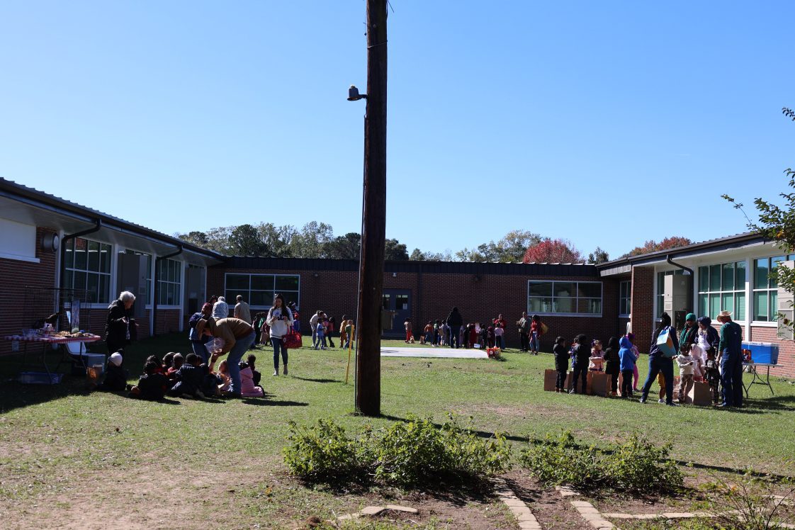 Kids in a school courtyard at a farmer's walk 