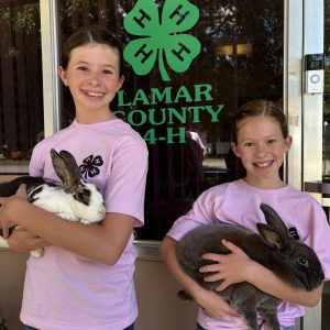 Knight sisters holding bunny at Lamar County 4-H