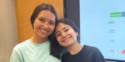 Two young girls posing for a picture at an EFNEP school event.