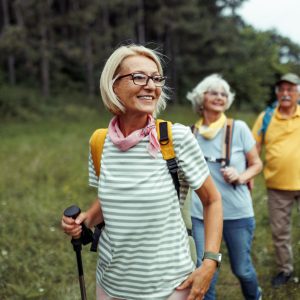 Mature woman enjoying her day hiking in the forest with friends