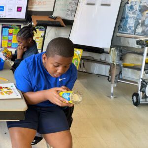 Teen Cuisine participant reading a food label