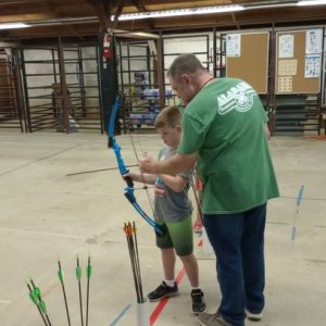 Tim Gothard working with 4-H members at a Shooting Sports event.