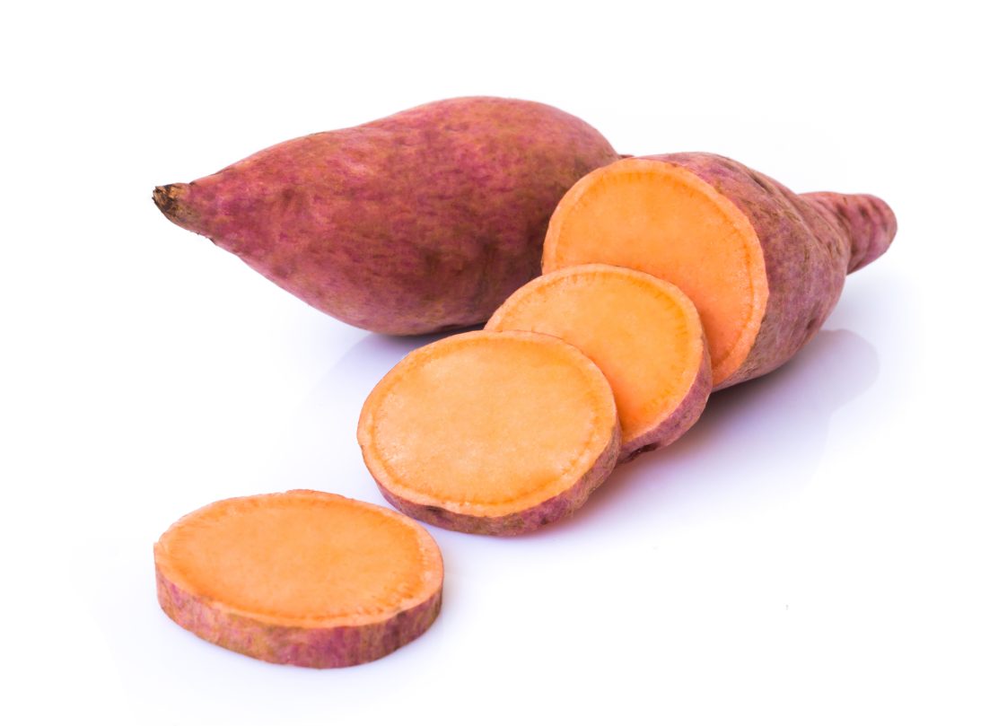 Sweet potato with slices on white background, raw food