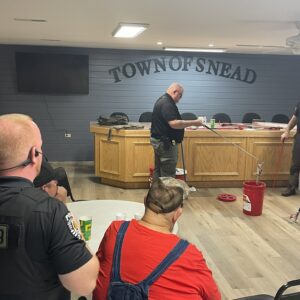 An instructor leading a course on snake identification and safety.