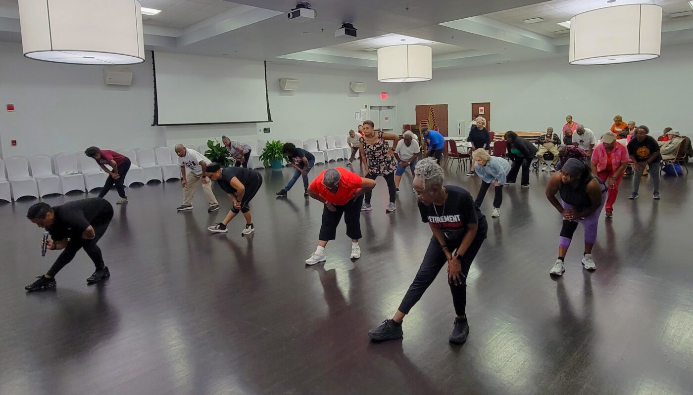 Participants working out at a Community Health Aerobic Motivational Program Initiating Optimal Nutrition (CHAMPION) program event.