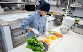 Chef chopping vegetables in a commercial kitchen