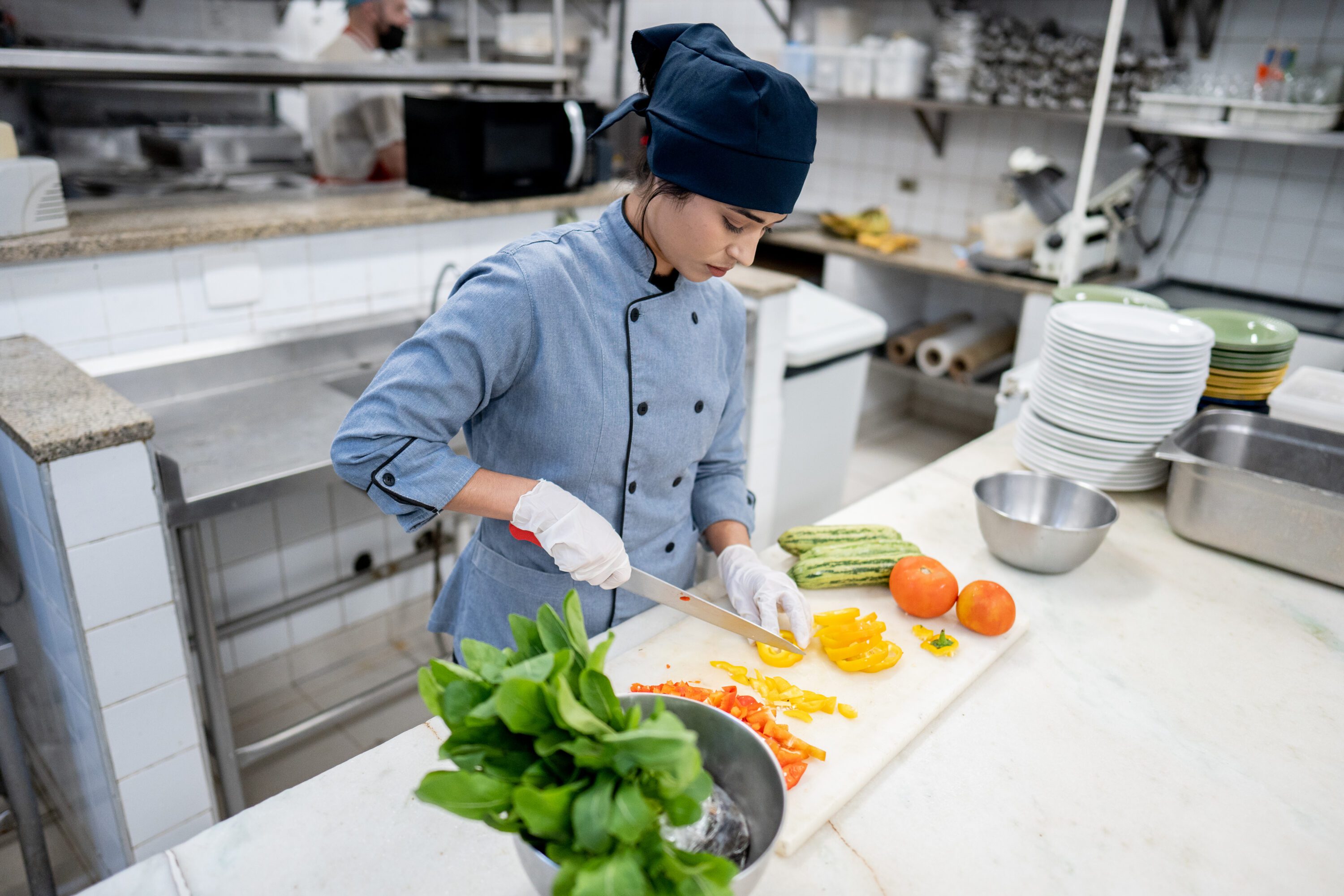 Chef chopping vegetables in a commercial kitchen