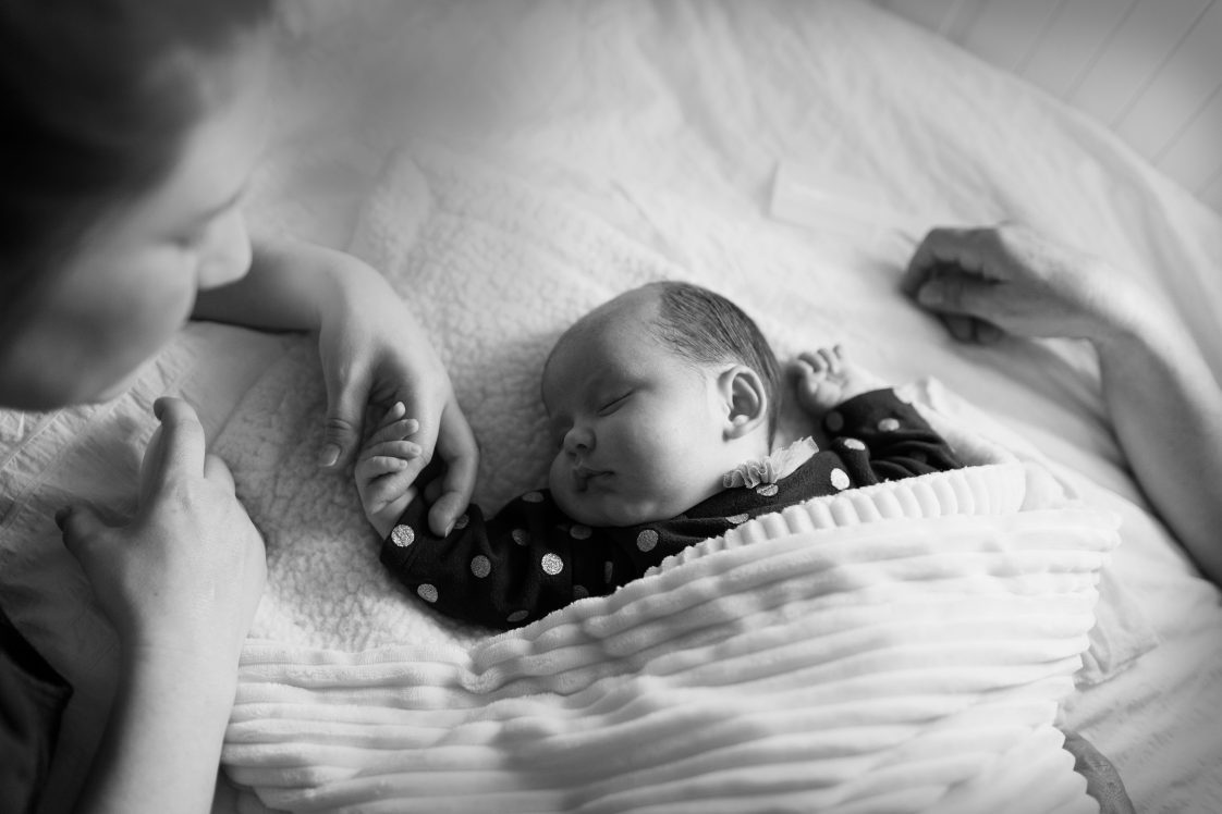 Mother holding baby girl hand