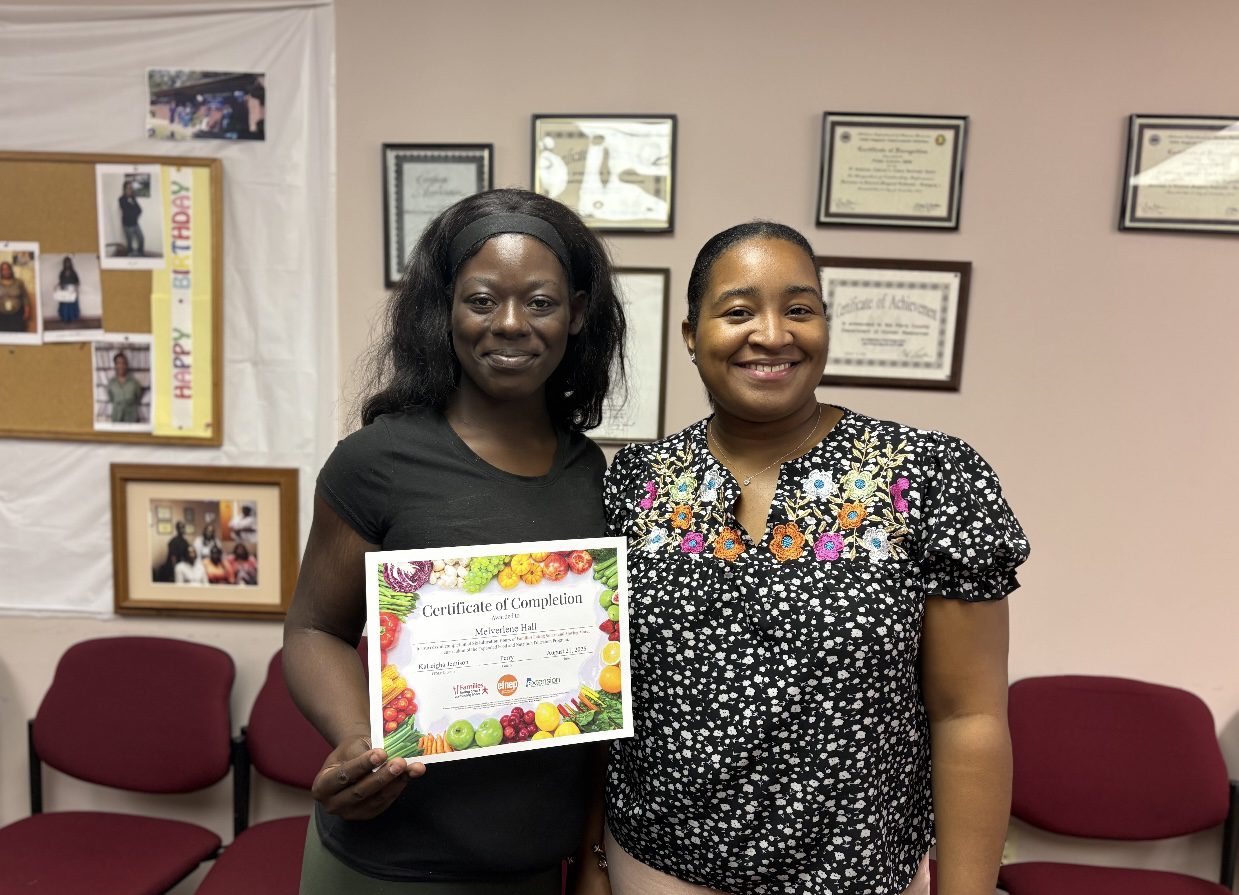 An EFNEP participant holding her certificate of completion. 