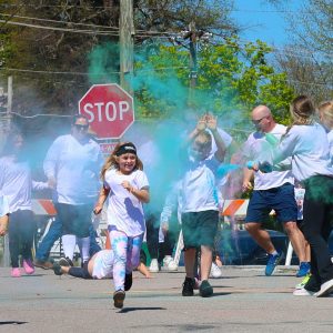 Kids running in a SANP-Ed color run.