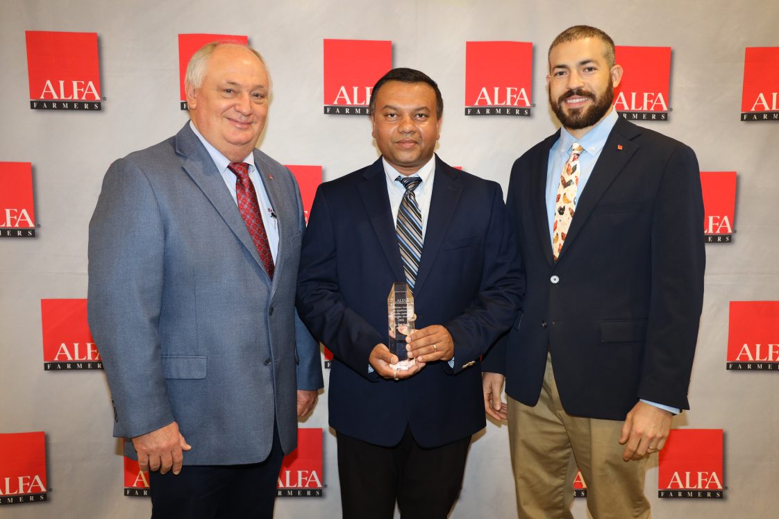 Prasad receives the Rittenour Award. Prasad (center) pictured with Parnell (left) and Christjohn (right).