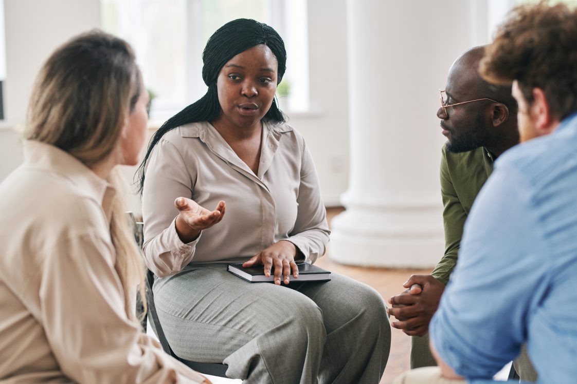 a woman holding conversations as part of a discussion group