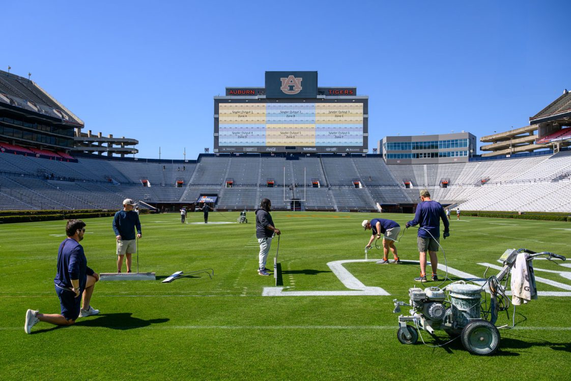 Pat Dye Field managers painting the field.