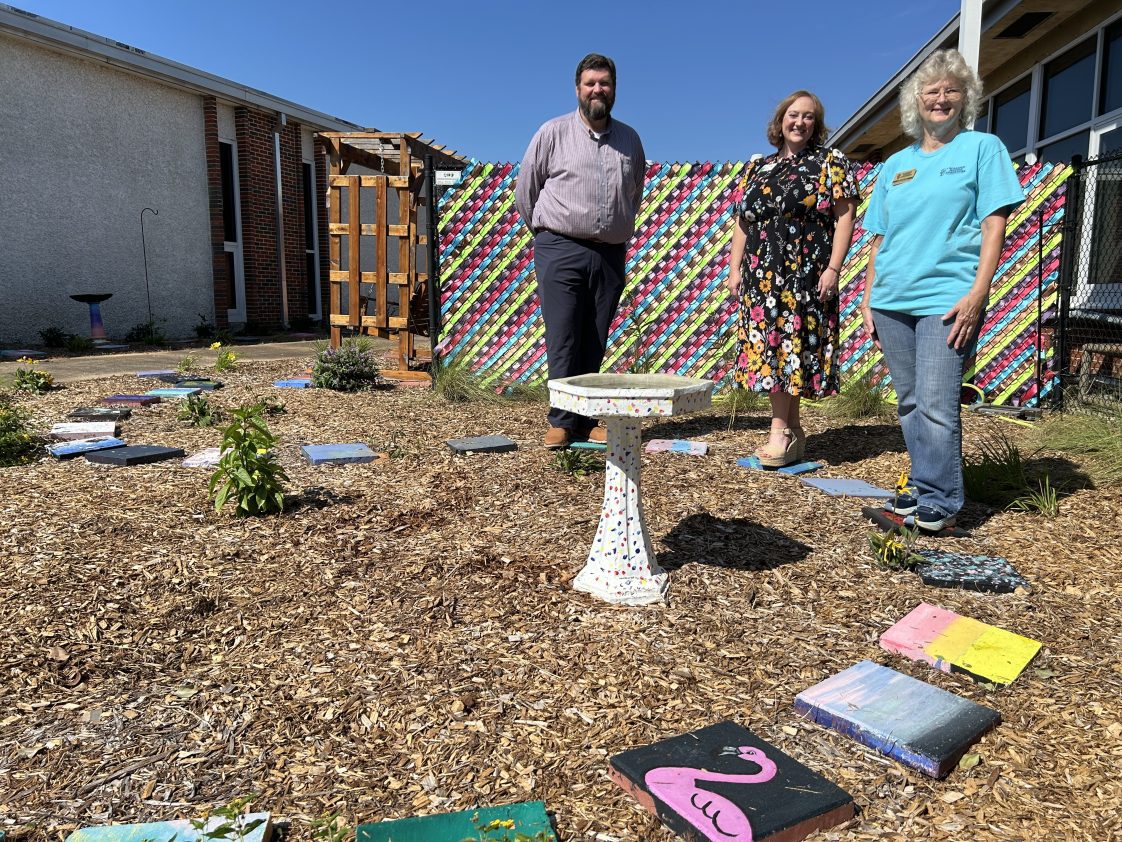 The Fall 2024 Claybank Master Gardeners intern class constructed a pollinator garden at D.A. Smith MIddle School in Ozark in Dale County. Students participated by painting stepping stones and birdbaths. The area is also used for classroom instruction. From left are Matthew Monson, Dale County Extension Director Melissa Voynich and Claybank Master Gardeners President Susan Rigsby. Now with the Dale County School System, Monson was principal of D.A. Smith Middle School when the pollinator garden was completed.