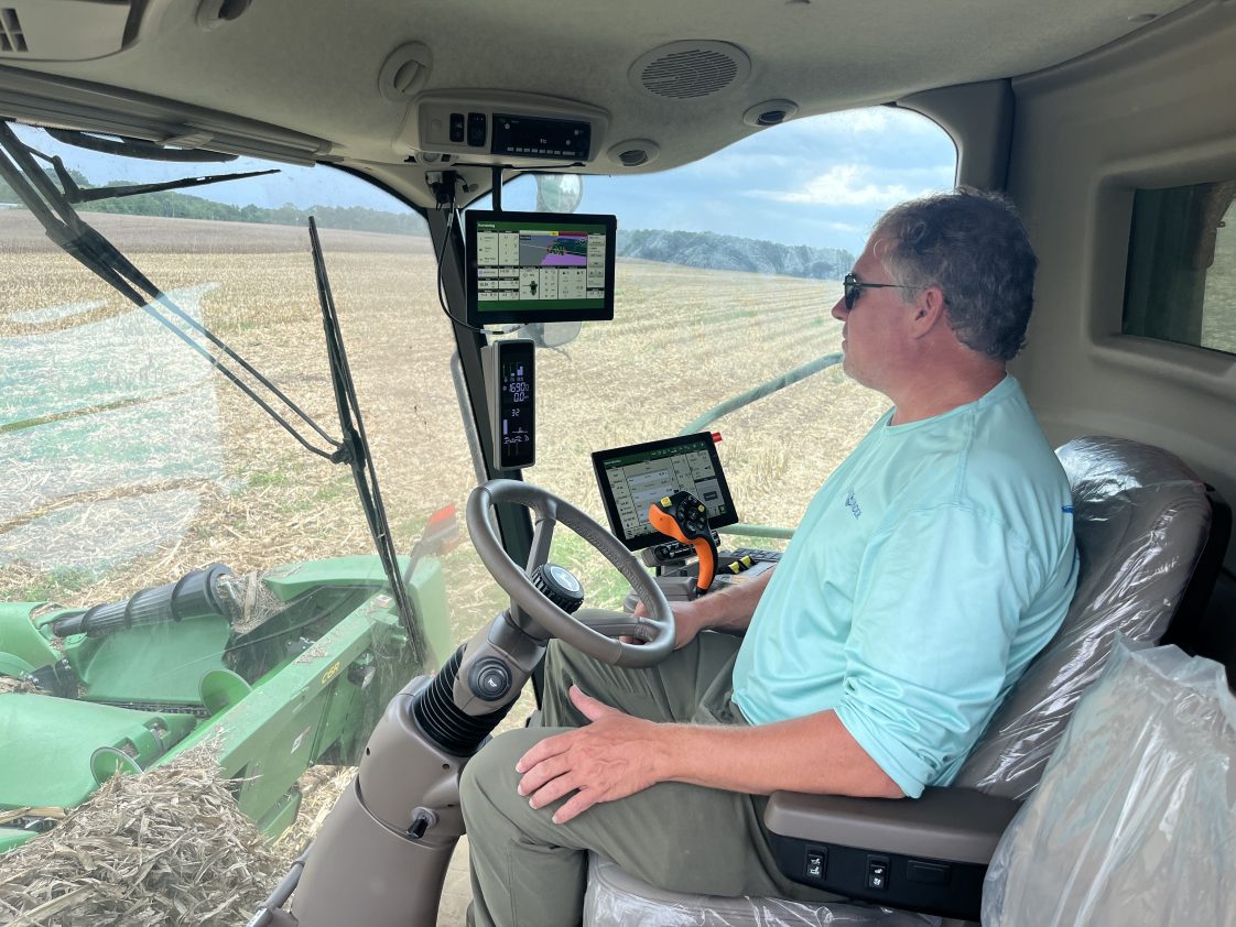 Farmer Will Curtis driving a combine.