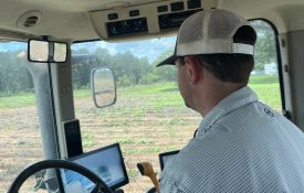 Garrett Dixon, a farmer in Lee County, inside the cab of a tractor.
