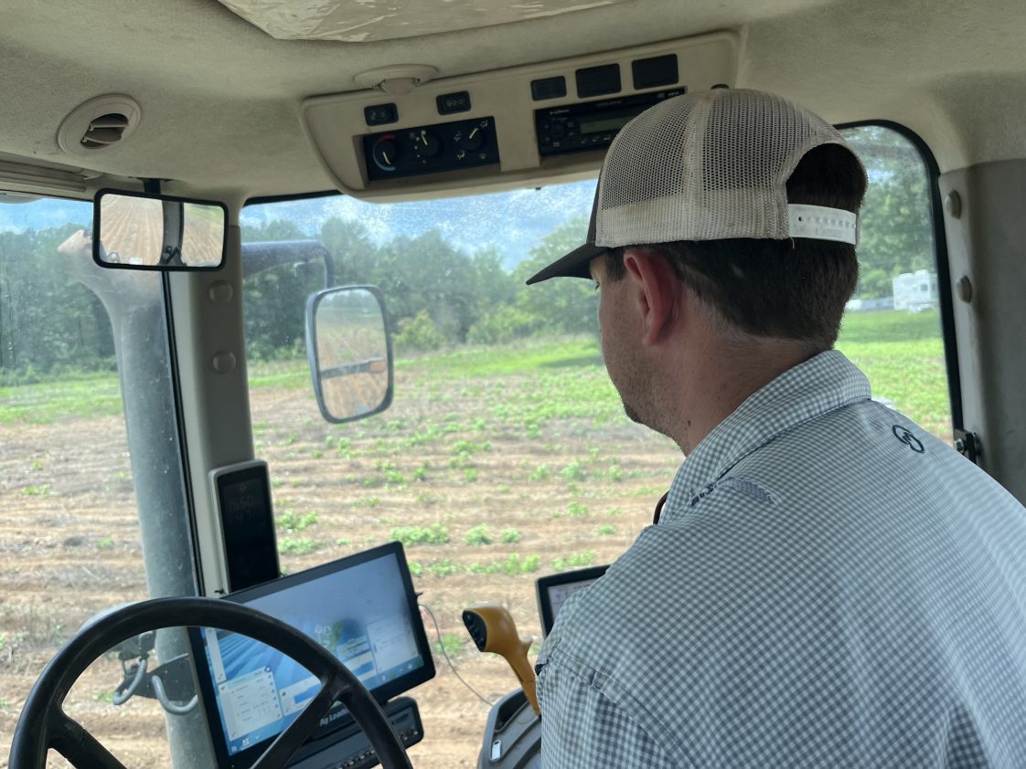 Garrett Dixon, a farmer in Lee County, inside the cab of a tractor.