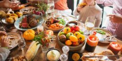 A holiday dinner table with many colorful food items.
