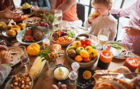 A holiday dinner table with many colorful food items.