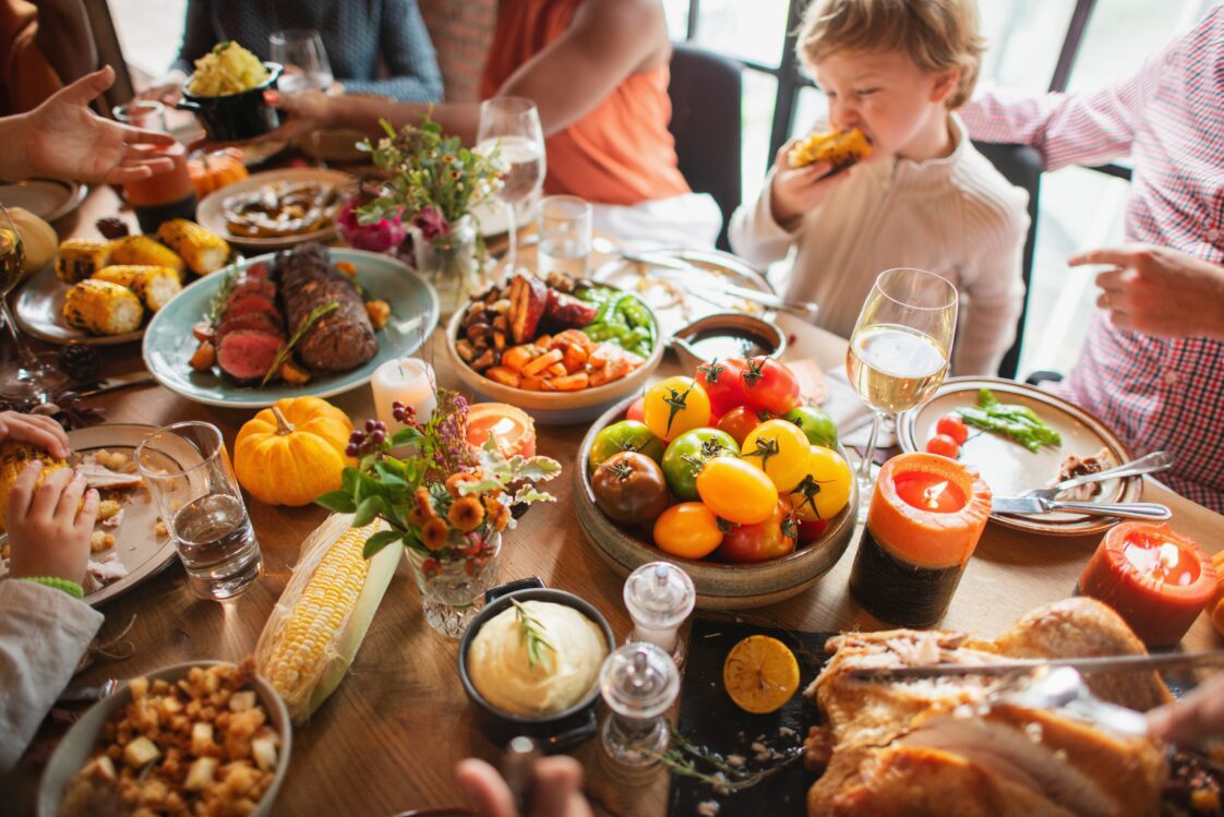 A holiday dinner table with many colorful food items.