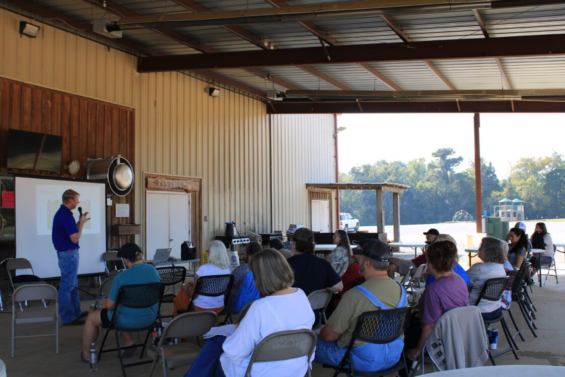 A crowd of people sitting and listening to a speaker at the Homesteading on a Half-Acre workshop.