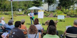 A group of people listens to a presentation during an in-person Operation Grow training.