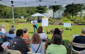 A group of people listens to a presentation during an in-person Operation Grow training.
