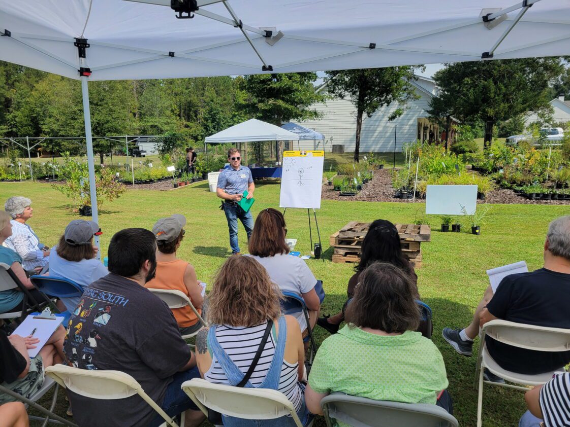 A group of people listens to a presentation during an in-person Operation Grow training.