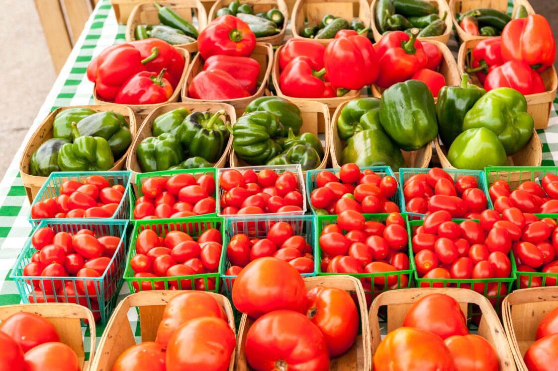 Peppers and tomatoes at a farmers market.