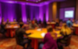 A blurry image of people at a conference award ceremony.