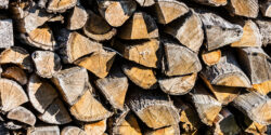 Stacked firewood logs textured background