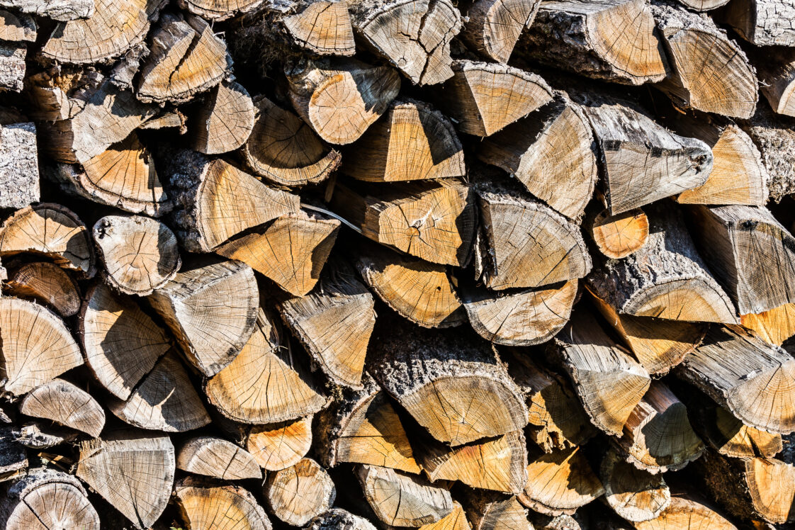 Stacked firewood logs textured background