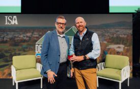 Paul Putman, TREE Fund president and chief executive officer, presenting the 2025 2025 Ken Ottman Volunteer Award to Beau Brodbeck.