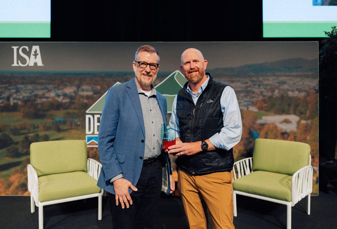 Paul Putman, TREE Fund president and chief executive officer, presenting the 2025 2025 Ken Ottman Volunteer Award to Beau Brodbeck.