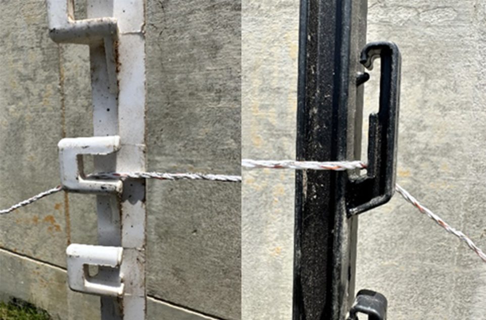 Two examples of wire catches on temporary fence posts: one white with a square catch and one black with a elongated catch.