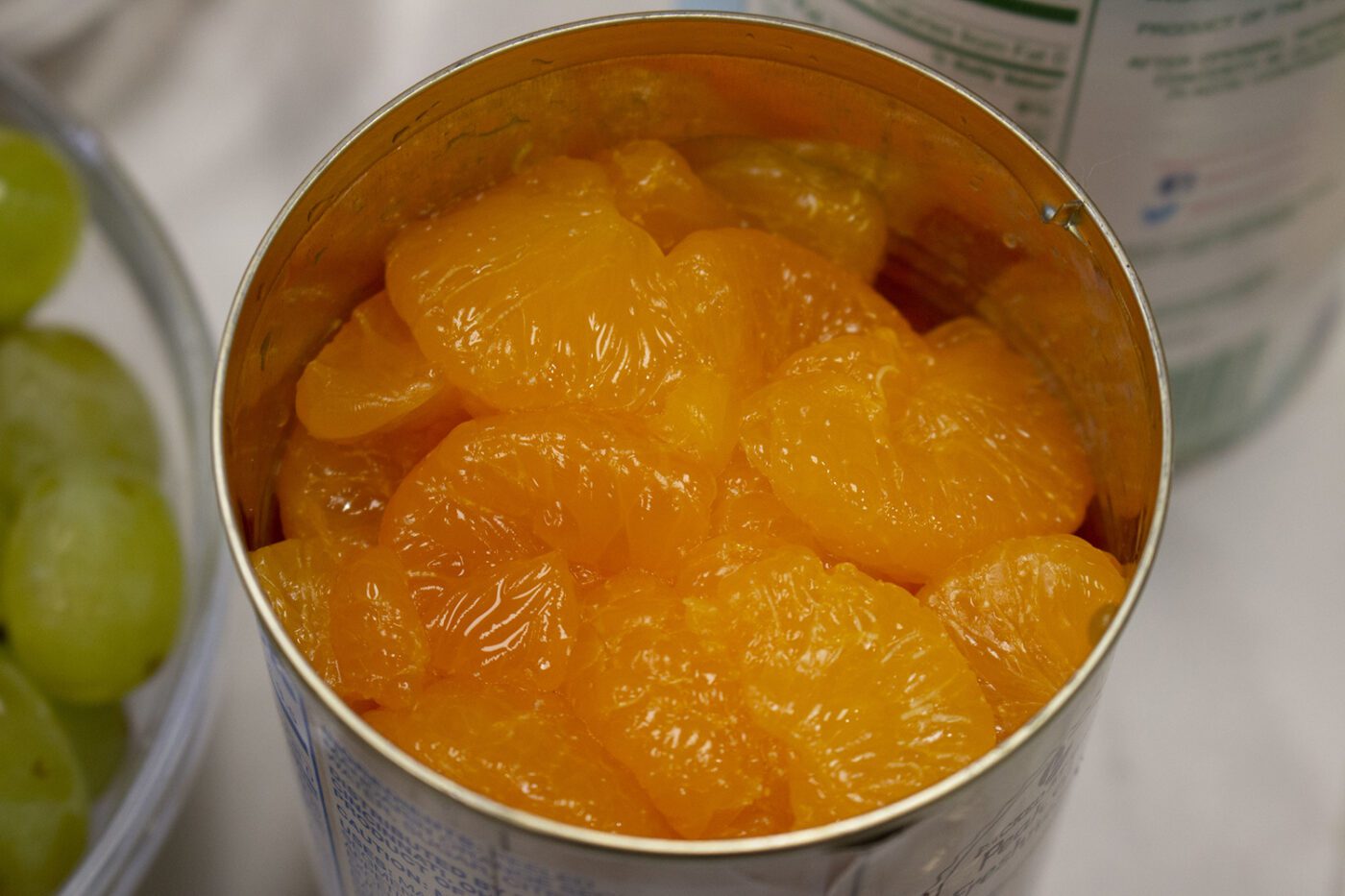 A closeup of mandarin oranges in a can.
