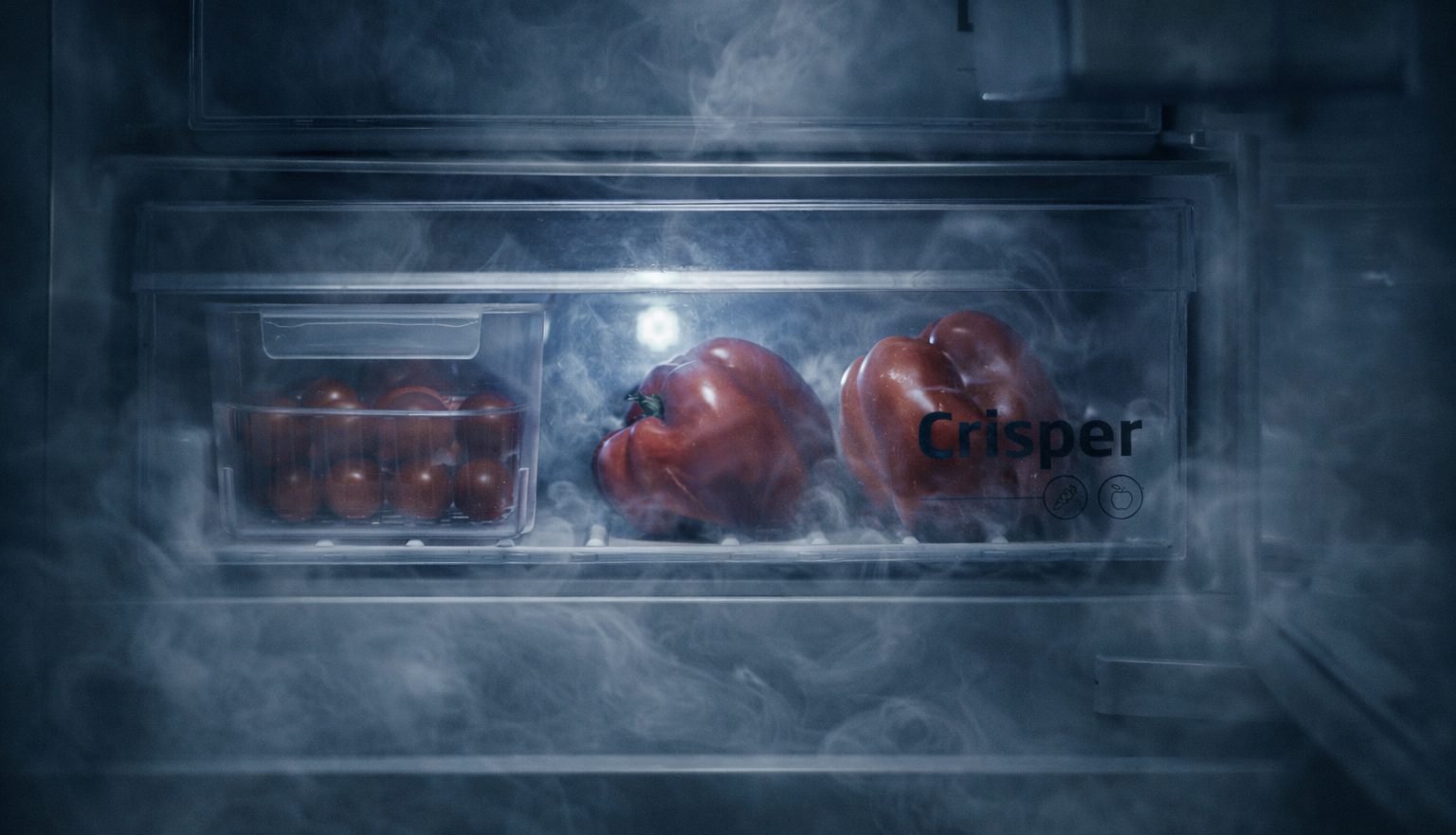 Vegetables in a crisper drawer with a smoky effect over them to resemble a graveyard.