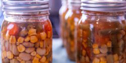 Clear jars of home-canned vegetable soup.