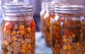 Clear jars of home-canned vegetable soup.