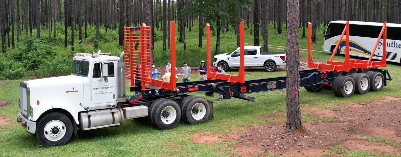 Figure 2. Auburn University log truck and trailer demonstration on transportation challenges and safety in Alabama. Weight and safety inspections, fuel costs, limited turn radius and maneuverability, braking distances, and axle weight and gross vehicle weight limits are some of the challenges.