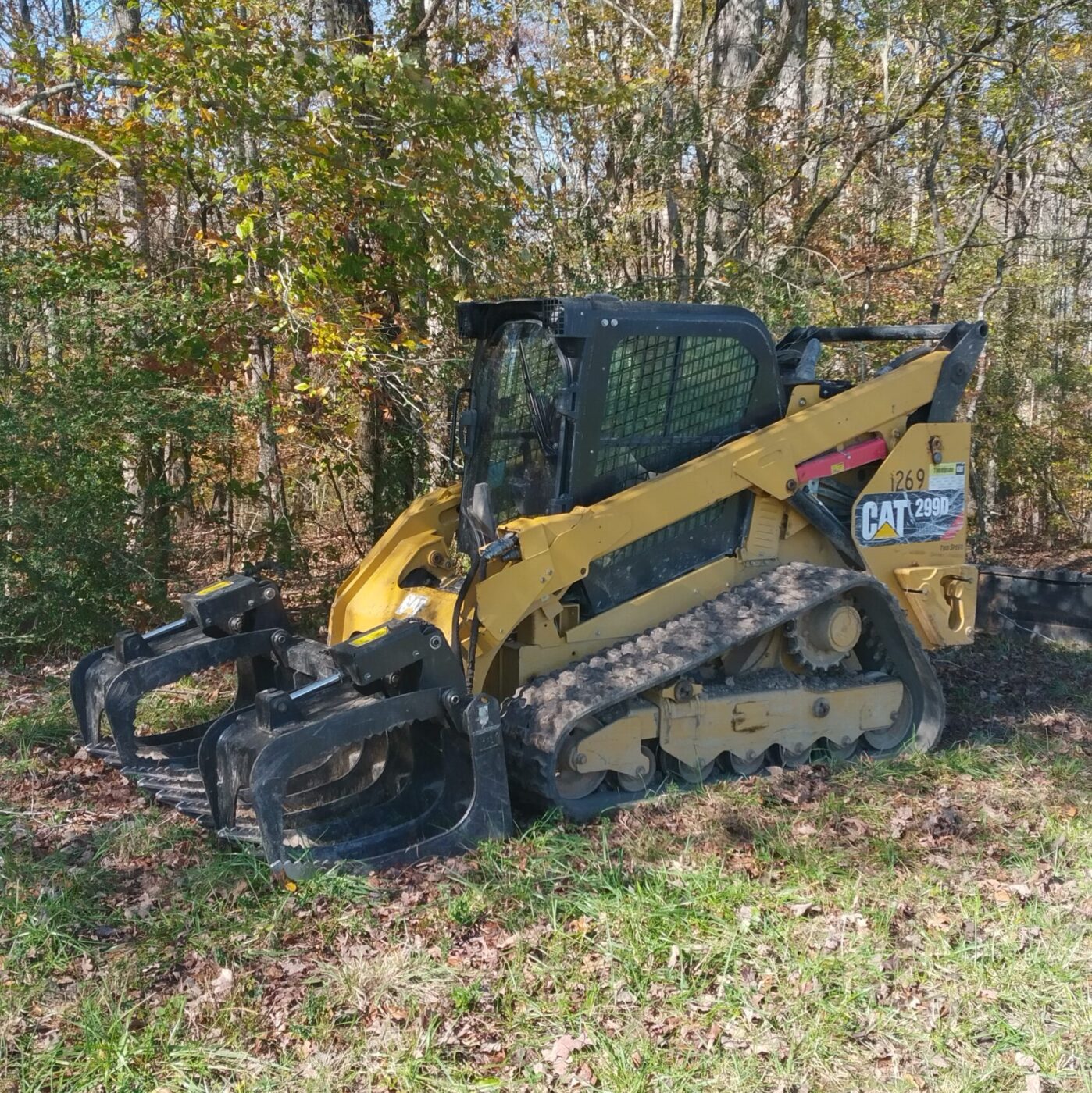 This skid steer is used by a mule logger in Tennessee to stack logs and load his log truck.